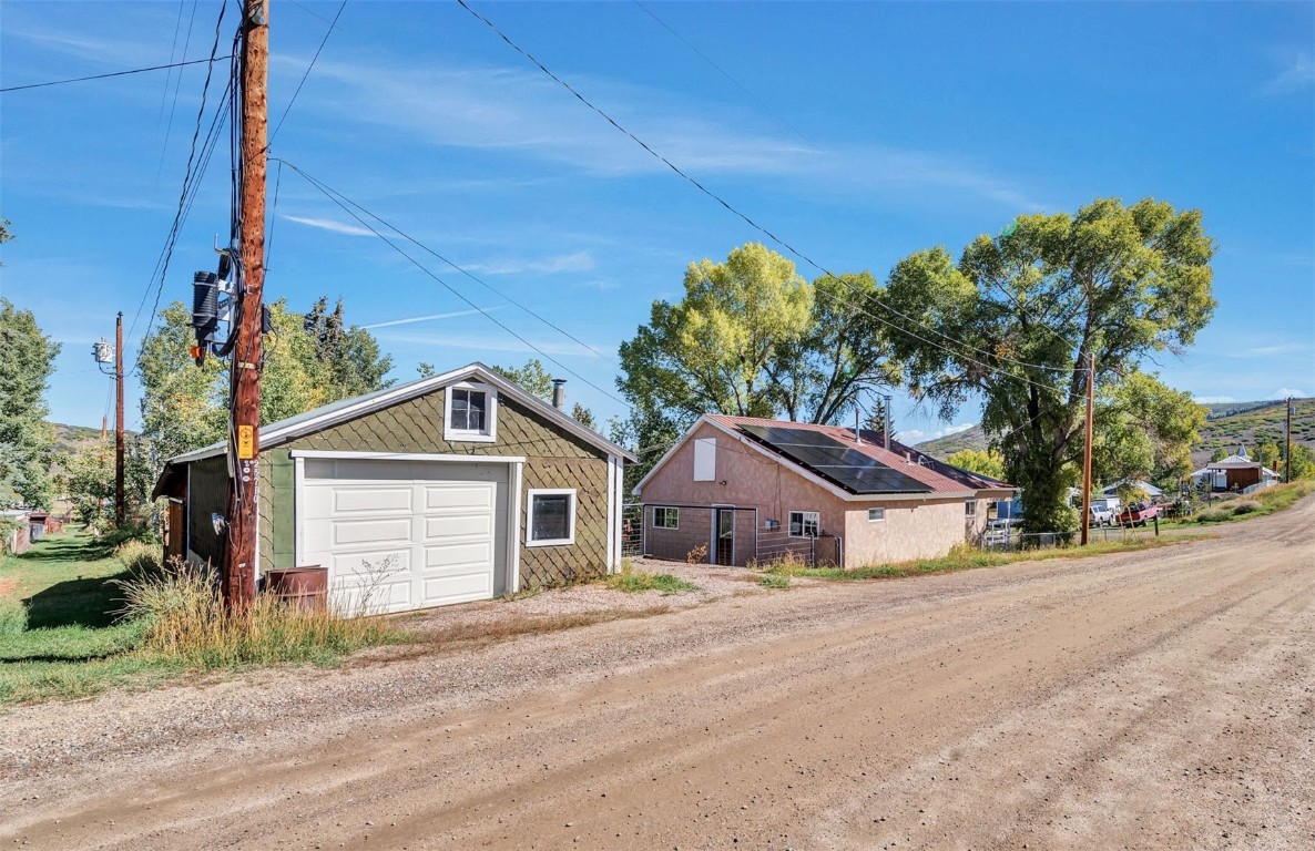 21505 4th Avenue Phippsburg, CO 80469 - Photo 40 of 44 a front view of a house with a yard and garage