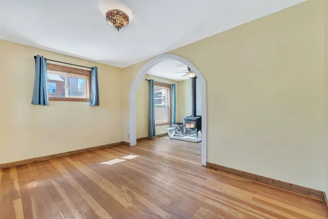 a view of a livingroom with wooden floor and a ceiling fan