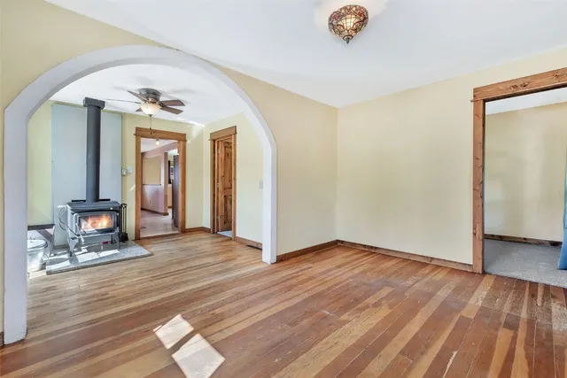 a view of a livingroom with wooden floor and a ceiling fan