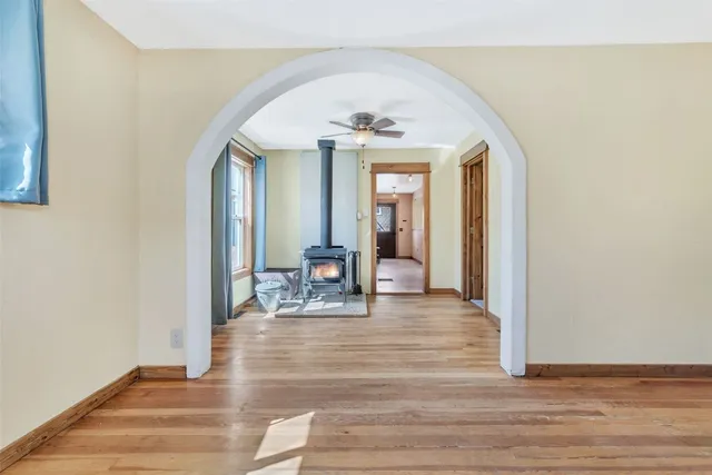 a view of a livingroom with wooden floor and furniture