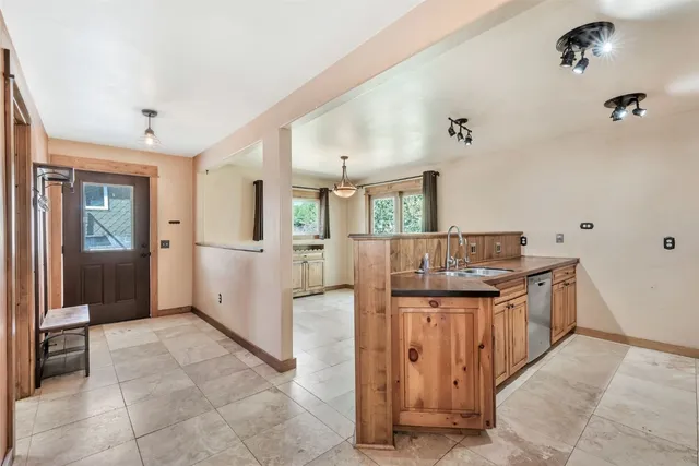 a bathroom with a granite countertop sink a mirror and a shower
