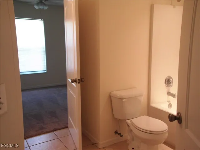a white toilet sitting next to a bathroom sink