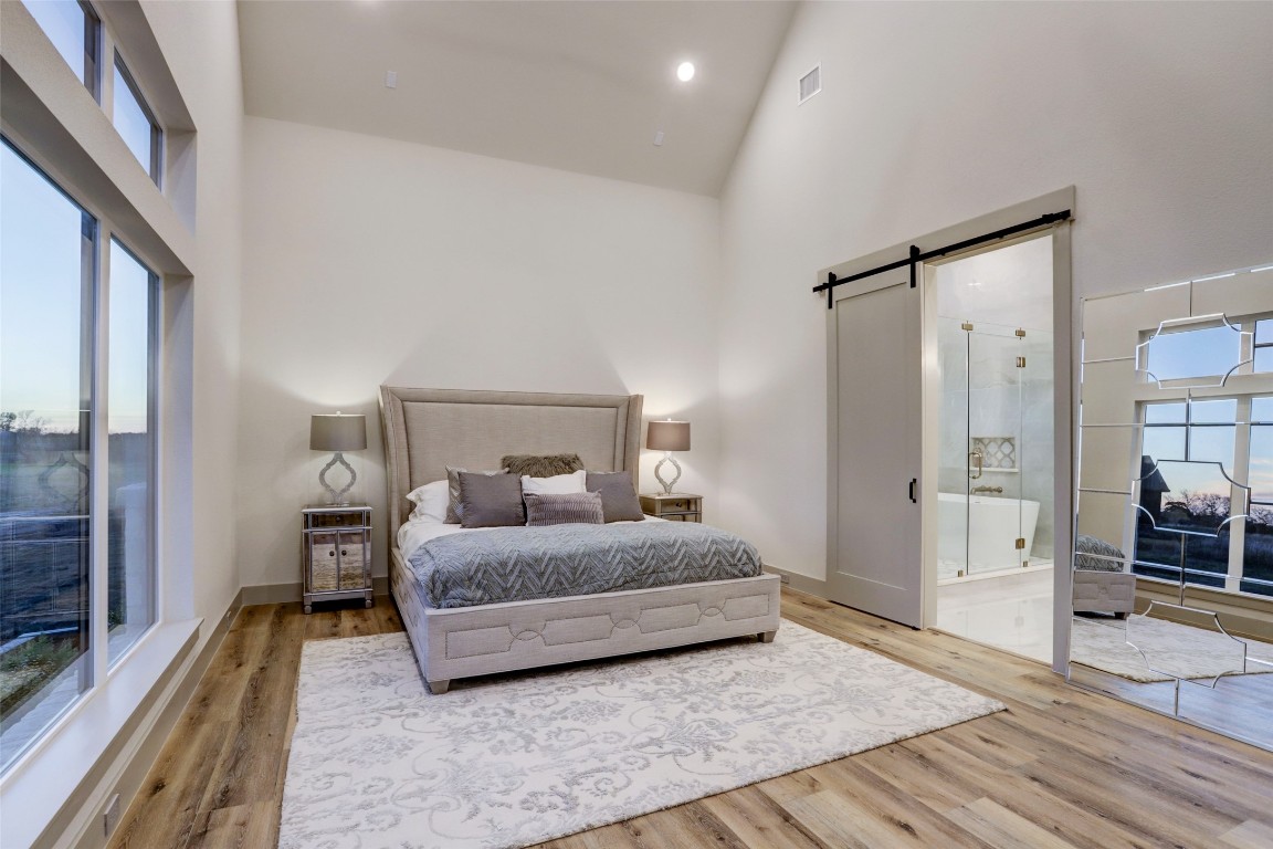 104 Turney Trace Round Top, TX 78954 - Photo 13 of 17 a bedroom with a bed and wooden floor