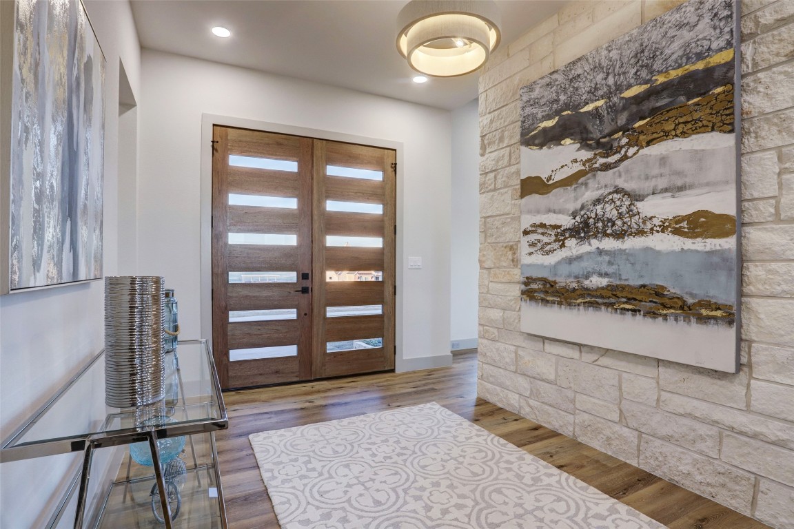 104 Turney Trace Round Top, TX 78954 - Photo 3 of 17 a view of front door with wooden floor