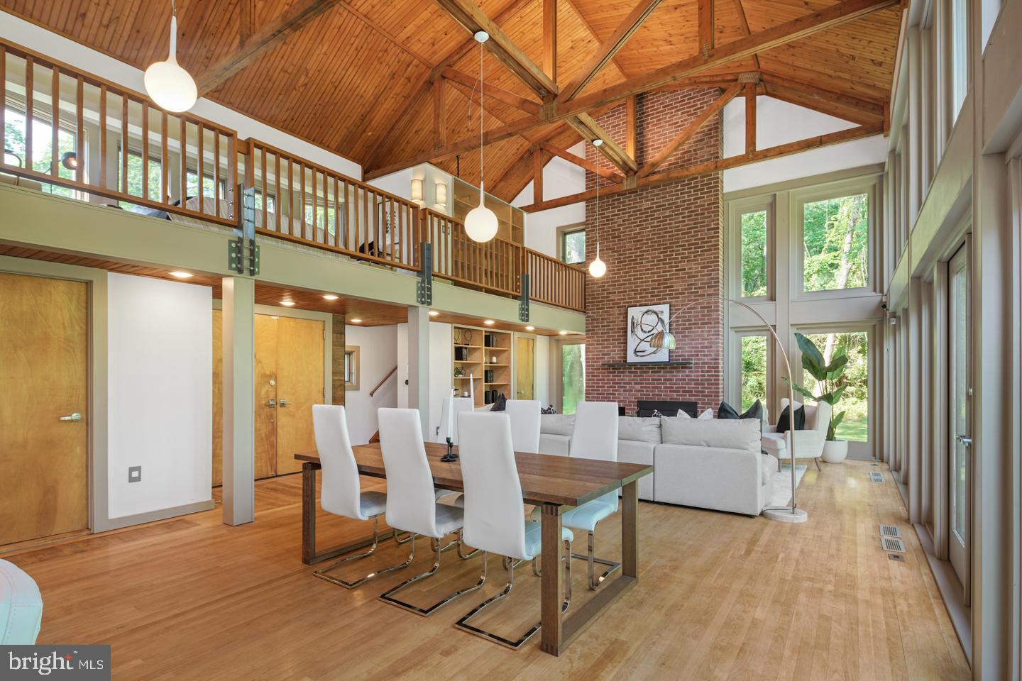 6024 Goshen Road Newtown Square, PA 19073 - Photo 2 of 15 a living room with furniture a wooden floor and a chandelier
