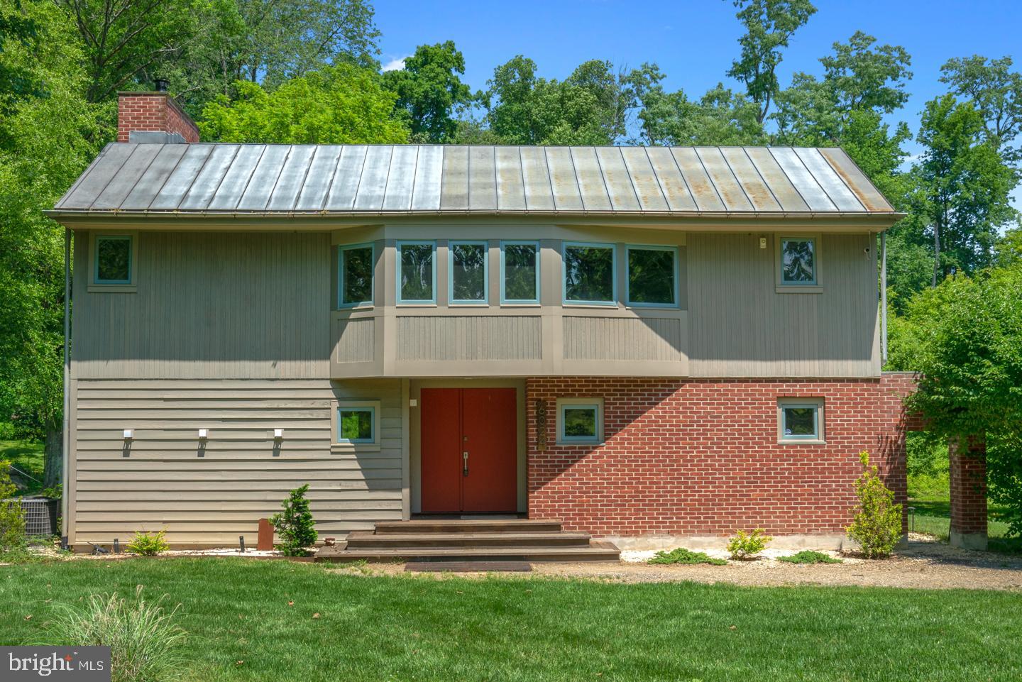 6024 Goshen Road Newtown Square, PA 19073 - Photo 14 of 15 a front view of a house with garden