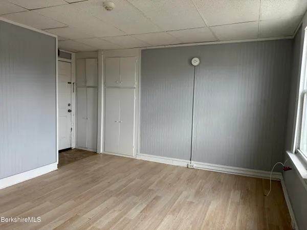 a view of an empty room with wooden floor