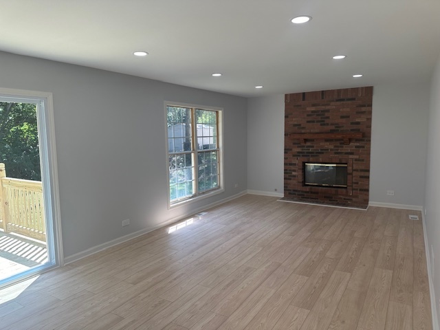 1311 Blue Ridge Parkway Algonquin, IL 60102 - Photo 2 of 21 an empty room with wooden floor fireplace and windows