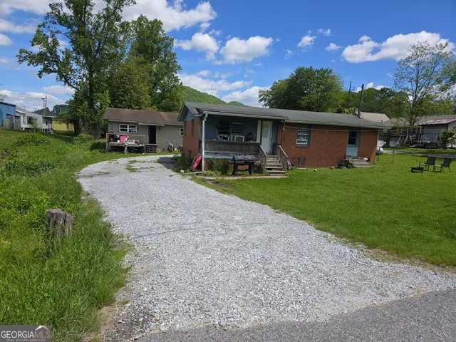 a view of a house with backyard and garden