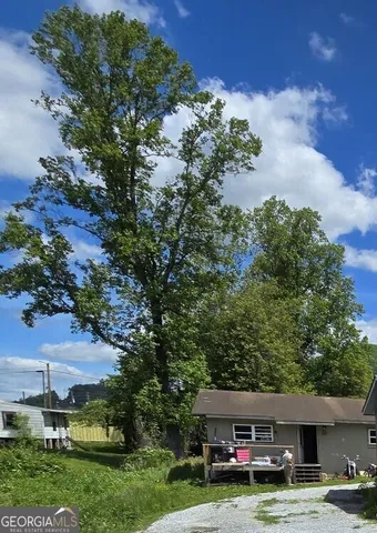 a car parked in front of a building with trees