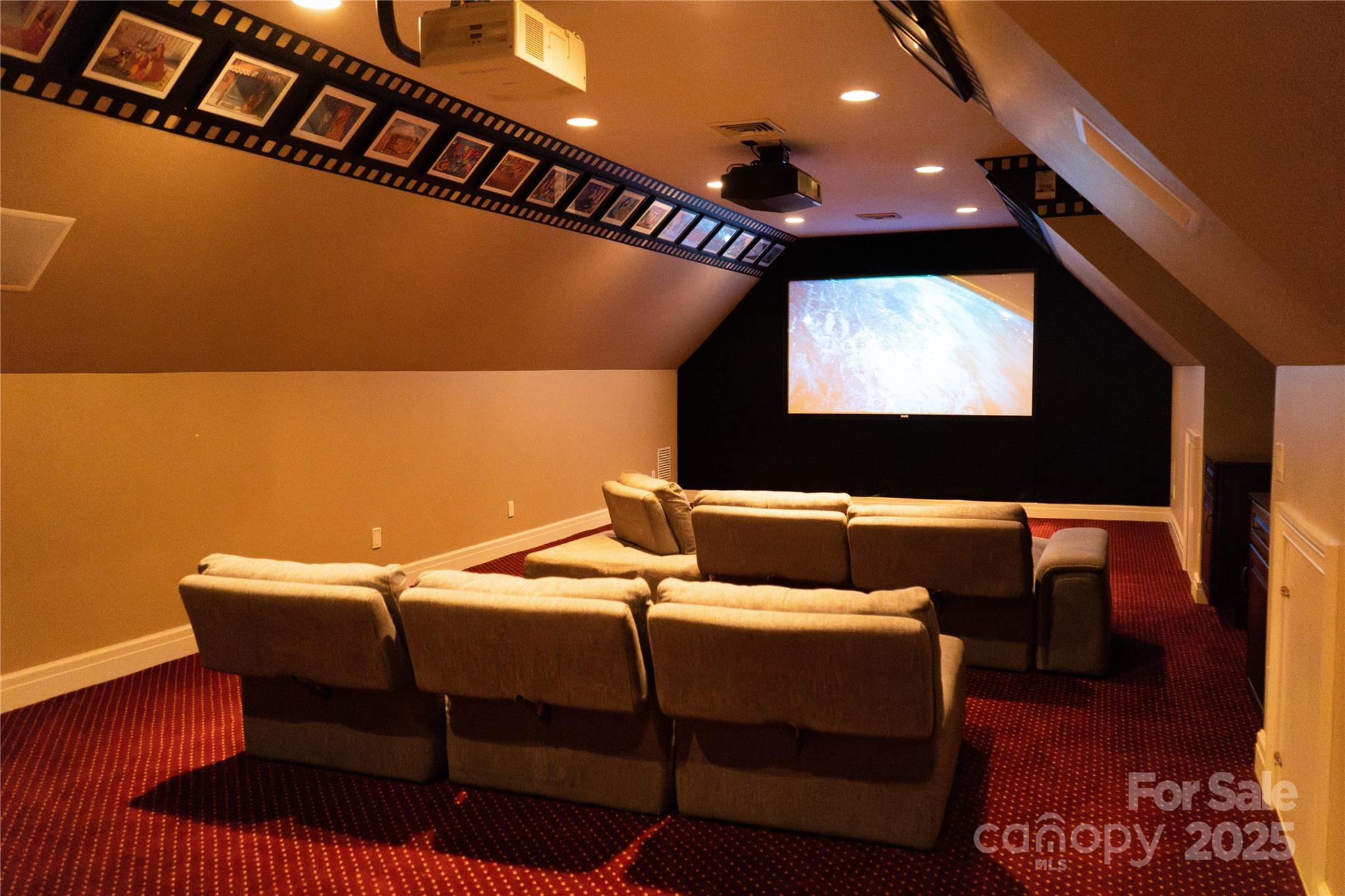 10600 Archer Road Davidson, NC 28036 - Photo 16 of 22 a projector room with furniture and a flat screen tv
