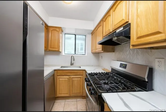 a kitchen with stainless steel appliances granite countertop a stove and a sink