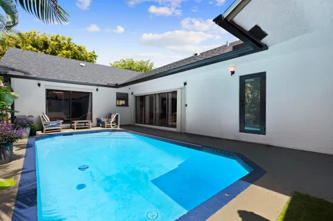 a view of a patio with swimming pool table and chairs