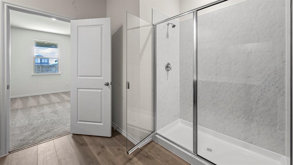 650 Glee Stem Road Lavon, TX 75166 - Photo 13 of 22 a bathroom with a glass shower door