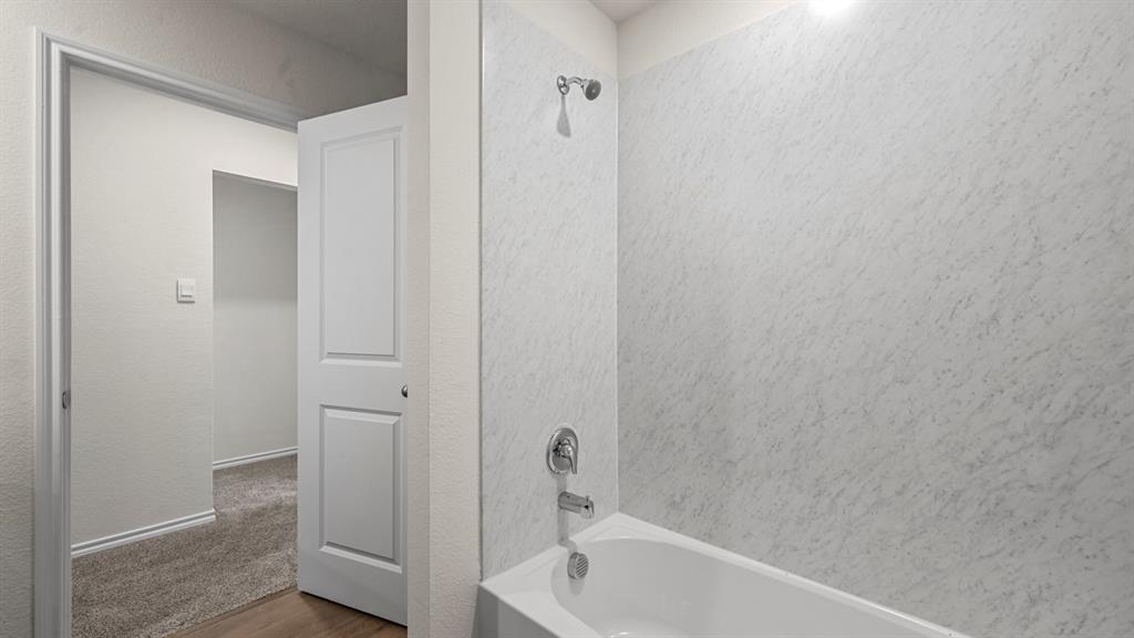 650 Glee Stem Road Lavon, TX 75166 - Photo 17 of 22 a bathroom with a tub and shower