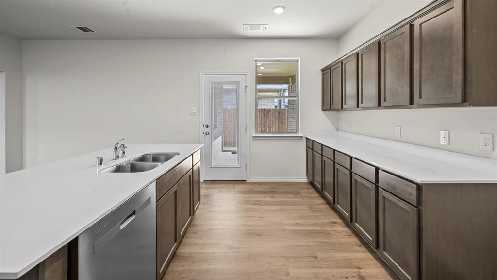 650 Glee Stem Road Lavon, TX 75166 - Photo 5 of 22 a kitchen with a sink and a stove top oven