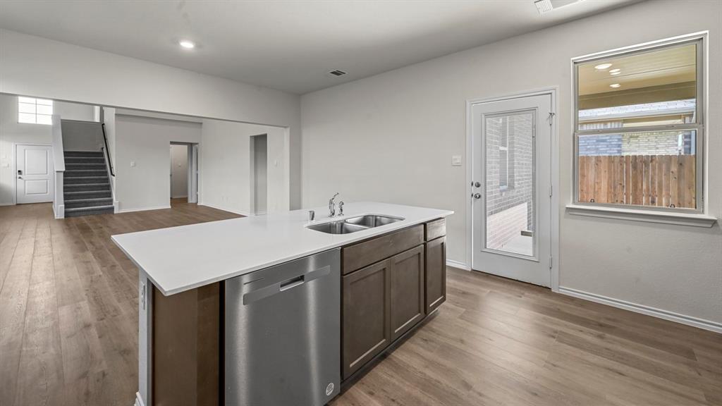 650 Glee Stem Road Lavon, TX 75166 - Photo 7 of 22 a kitchen with a sink cabinets and wooden floor