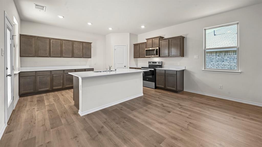 650 Glee Stem Road Lavon, TX 75166 - Photo 8 of 22 a kitchen with stainless steel appliances granite countertop a stove top oven a sink dishwasher and a refrigerator