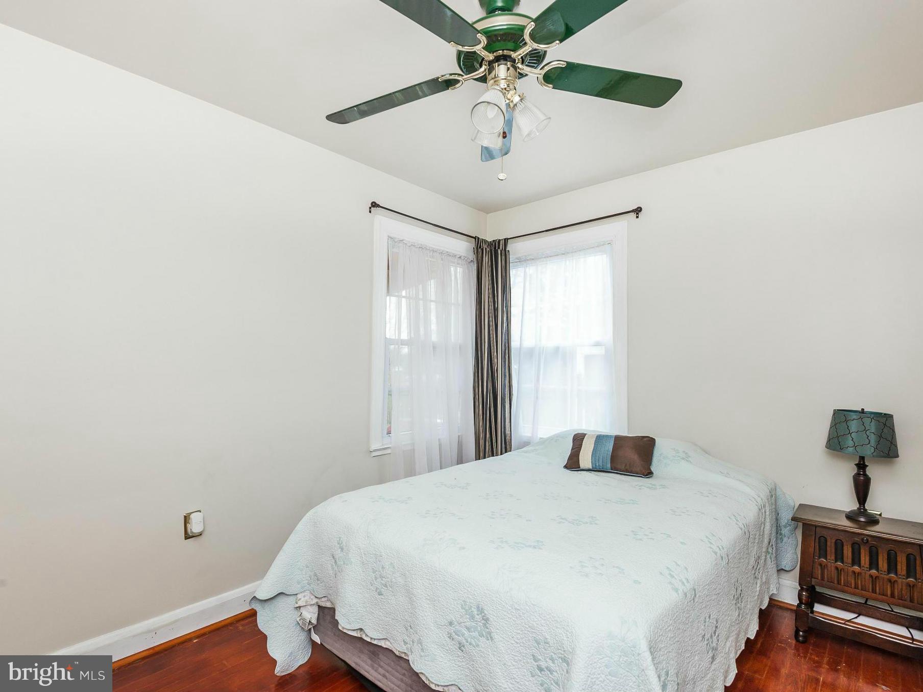 411 Aigburth Road Towson, MD 21286 - Photo 14 of 23 a bedroom with a bed and a chandelier