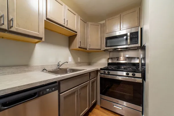 a kitchen with a sink stove and microwave