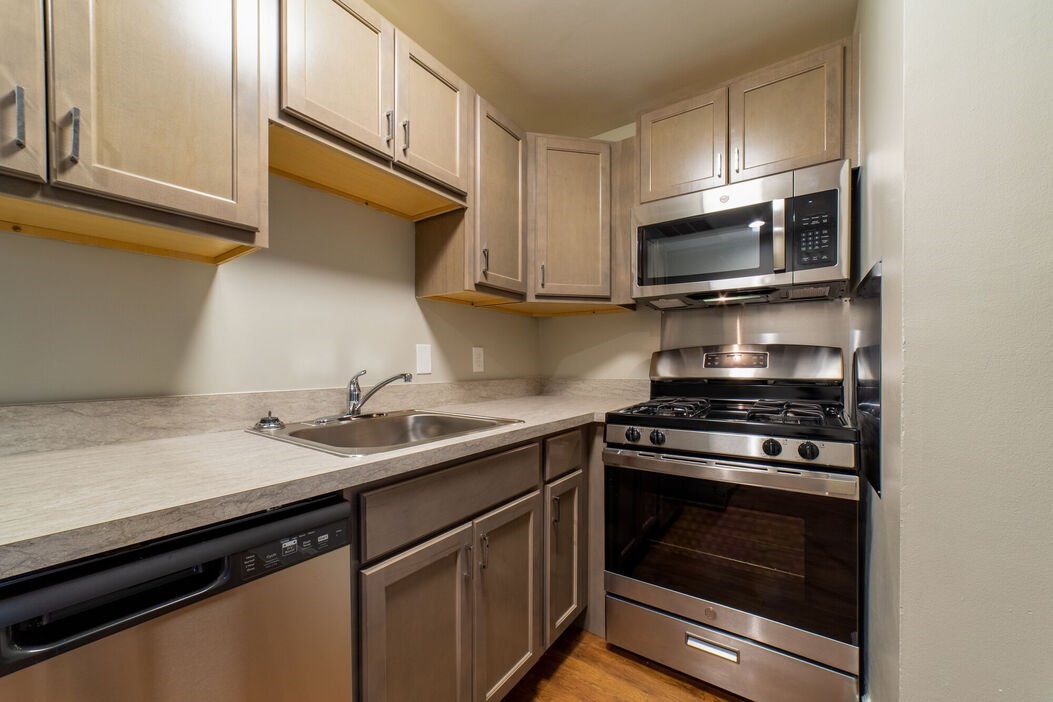 41 Prospect Street Webster, MA 01570 - Photo 3 of 6 a kitchen with a sink stove and microwave