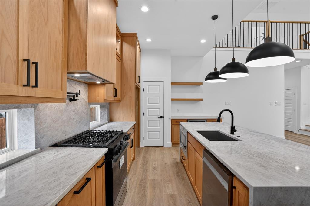 2007 North Montclair Avenue Dallas, TX 75208 - Photo 6 of 25 a kitchen with stainless steel appliances granite countertop a sink a stove and a wooden floors