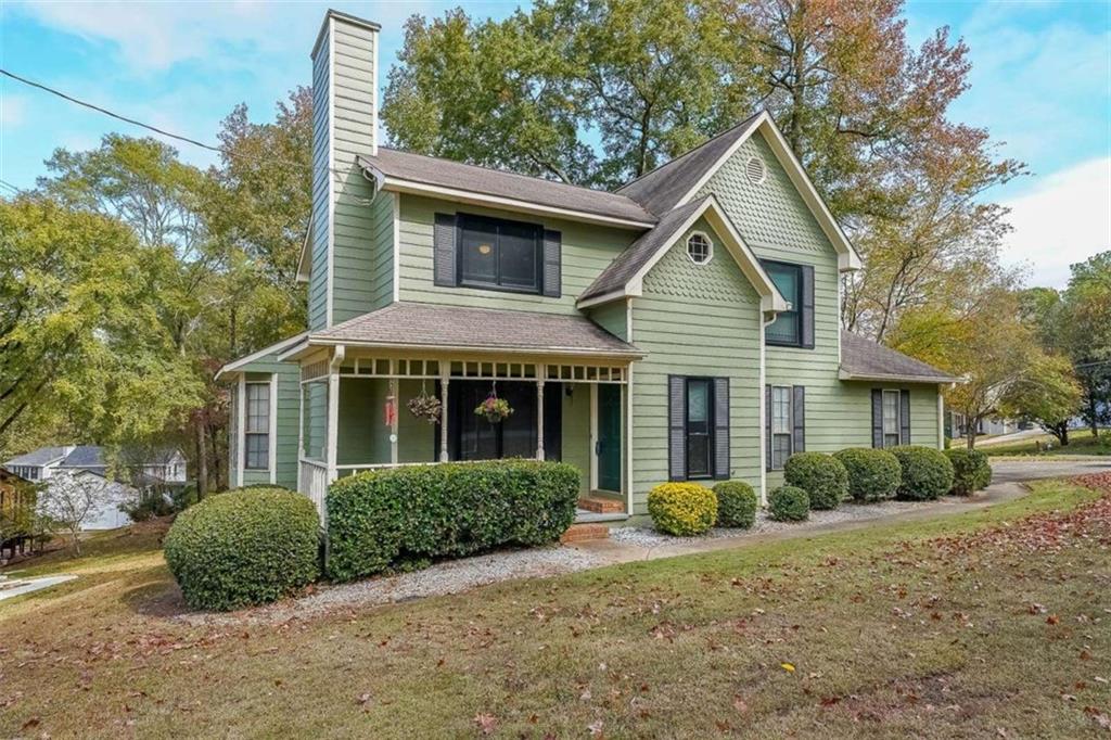 a view of a house with a yard and potted plants