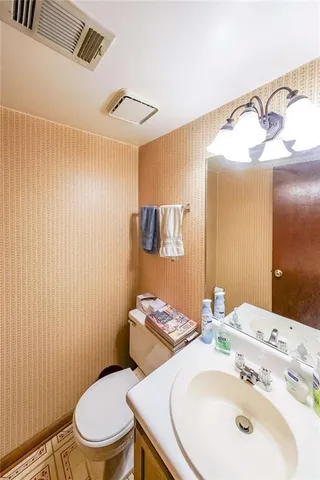 a bathroom with a sink a toilet and shower curtain