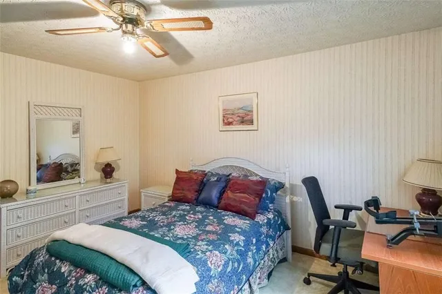 a bedroom with a bed and a desk