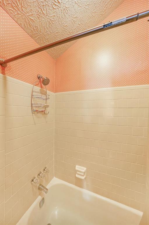 183 Timothy Lane Northwest Lilburn, GA 30047 - Photo 26 of 32 a bathroom with a shower and a bathtub