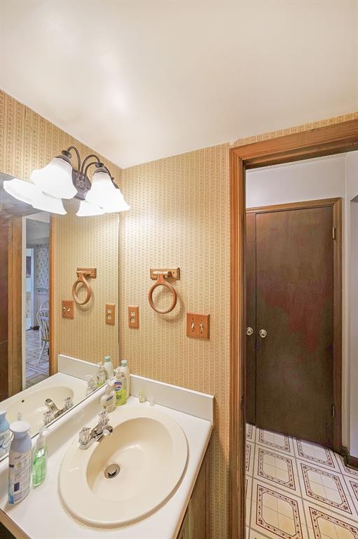 183 Timothy Lane Northwest Lilburn, GA 30047 - Photo 27 of 32 a bathroom with a sink and a mirror