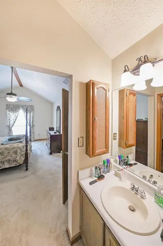 a en suite bathroom with a double vanity sink and a mirror