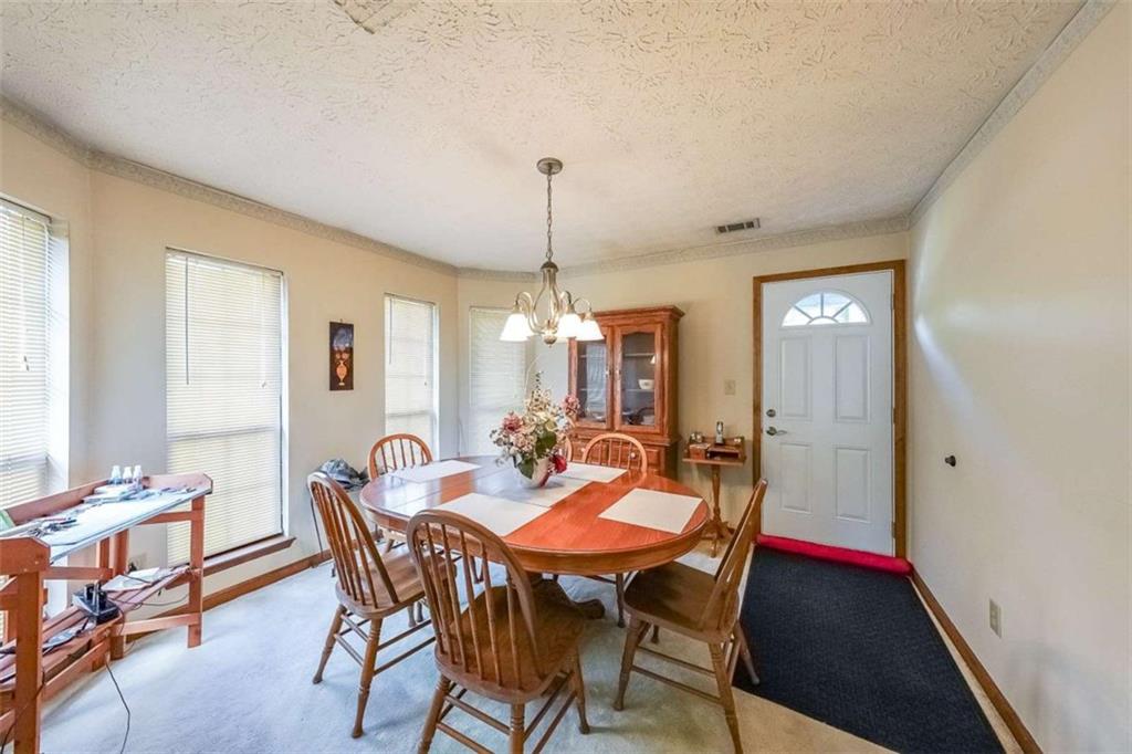 183 Timothy Lane Northwest Lilburn, GA 30047 - Photo 7 of 32 a view of a dining room with furniture and window