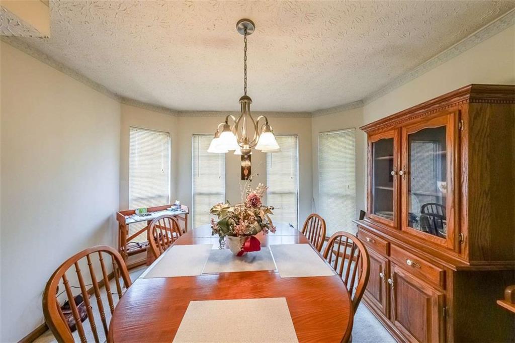 183 Timothy Lane Northwest Lilburn, GA 30047 - Photo 9 of 32 a view of a dining room with furniture and a chandelier