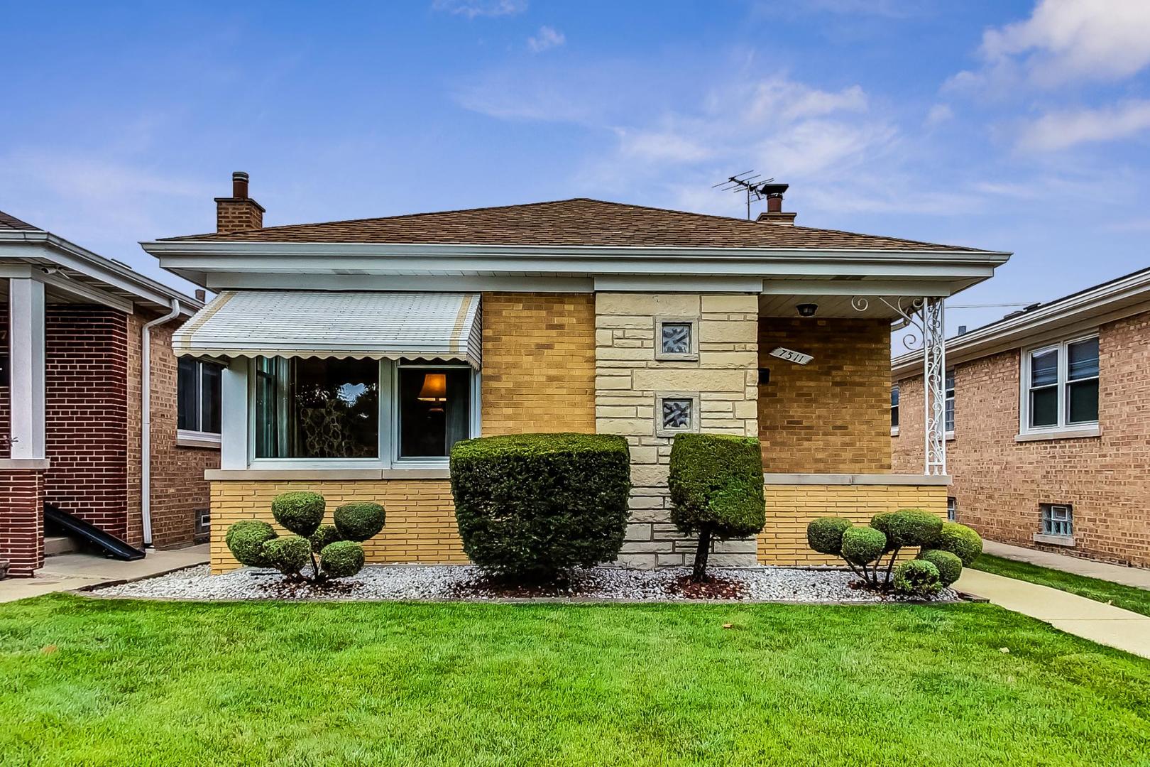 7511 North Oconto Avenue Chicago, IL 60631 - Photo 1 of 37 a front view of a house with a yard