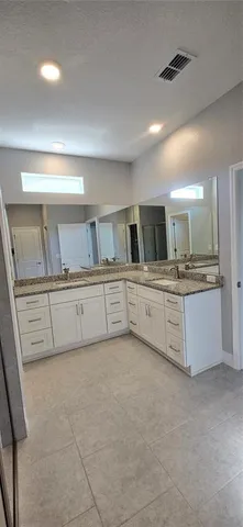 a large kitchen with cabinets and stainless steel appliances