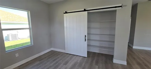 a view of walk in closet with empty racks