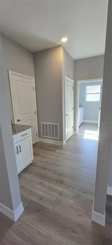 a view of empty room with wooden floor