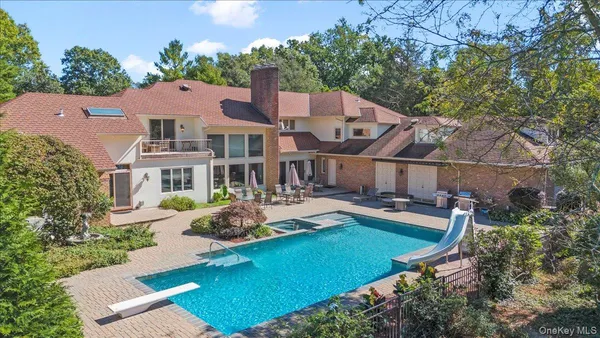 an aerial view of a house with swimming pool garden and patio