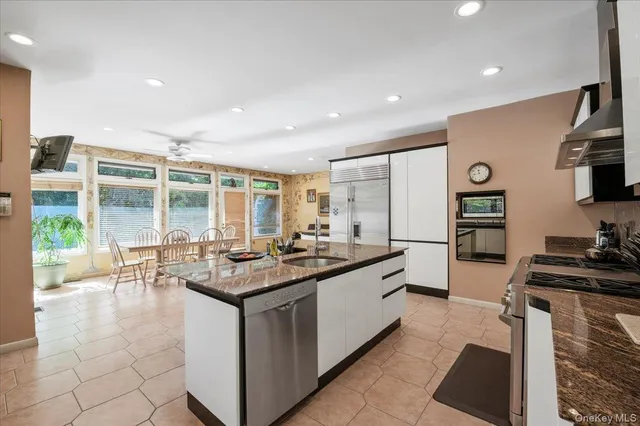 a kitchen with stainless steel appliances granite countertop a stove oven and a sink with granite countertops
