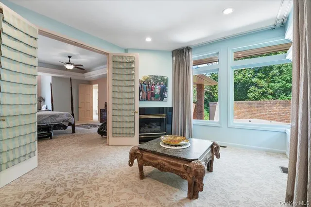 a living room with furniture a fireplace and large window