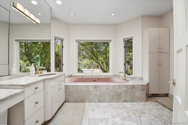 a large spacious bathroom with a large tub shower and sink