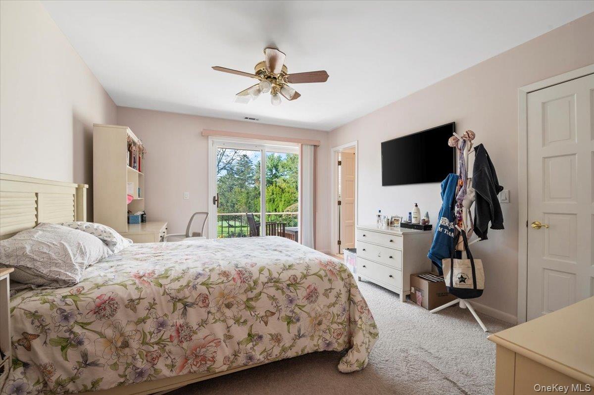 12 Ridge Court Glen Head, NY 11545 - Photo 38 of 46 a bedroom with a bed and a flat screen tv