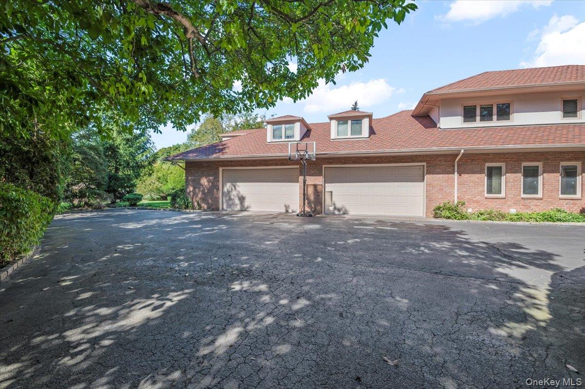12 Ridge Court Glen Head, NY 11545 - Photo 39 of 46 a front view of a house with a yard and a garage