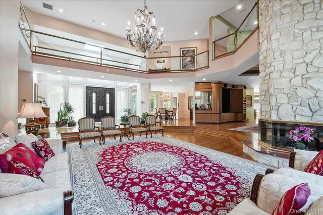 a living room with furniture and a chandelier