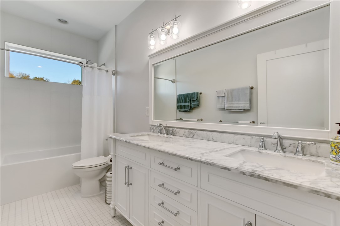 521 Bonnieview Road Fernandina Beach, FL 32034 - Photo 23 of 35 a bathroom with a granite countertop sink a toilet a mirror and shower