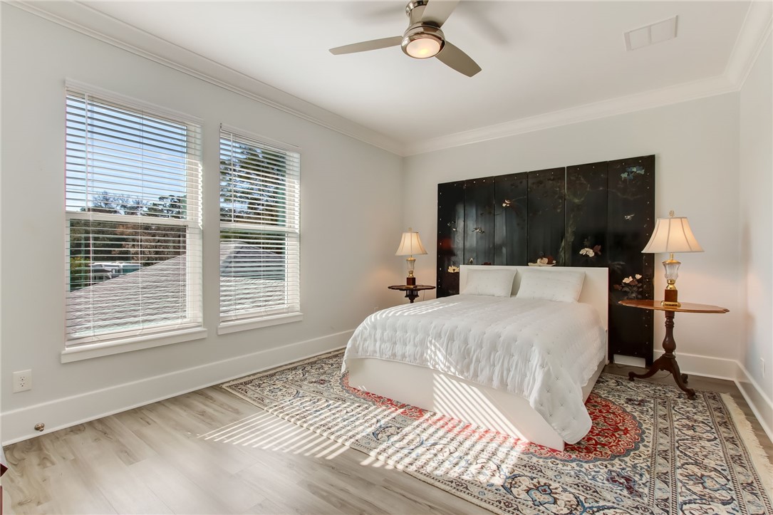 521 Bonnieview Road Fernandina Beach, FL 32034 - Photo 24 of 35 a bedroom with a large bed and a tv
