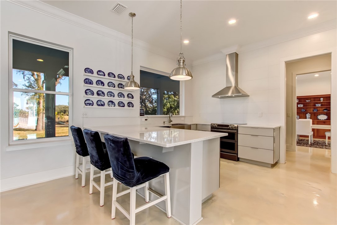 521 Bonnieview Road Fernandina Beach, FL 32034 - Photo 8 of 35 a kitchen with a sink and chairs