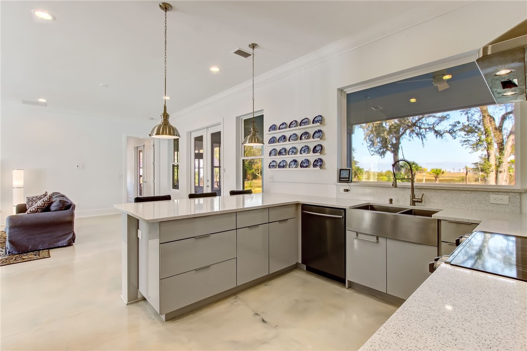 521 Bonnieview Road Fernandina Beach, FL 32034 - Photo 9 of 35 a kitchen with stainless steel appliances granite countertop a sink a stove and a wooden floor