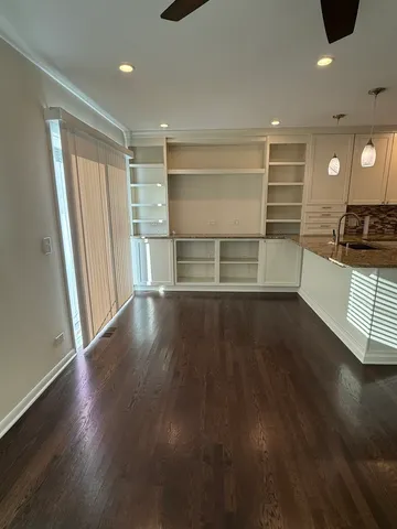 a view of a room with wooden floor and sink